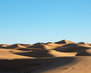 wide-shot-of-sand-dunes-in-a-desert-at-daytime_181624-2042