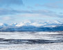 beautiful-shot-of-snowy-field-and-mountains-in-the-distance-in-the-north-of-sweden_181624-14986